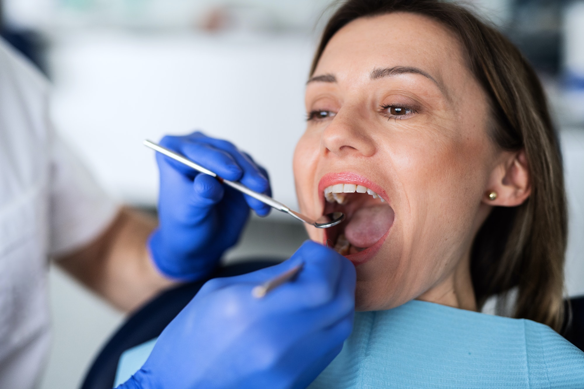 A woman has a dental check-up in dentist surgery